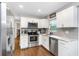 Bright kitchen featuring white cabinets, stainless steel appliances, and marble countertops at 3547 55Th N St, St Petersburg, FL 33710