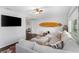 Spacious living room with modern decor, features a large sectional sofa and a surfboard accent at 3547 55Th N St, St Petersburg, FL 33710