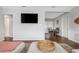 Open-concept living room seamlessly connecting to the dining area, featuring modern decor and a TV at 3547 55Th N St, St Petersburg, FL 33710