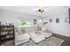 Bright living room featuring a large, comfortable sectional sofa, stylish rug, and lots of natural light at 3547 55Th N St, St Petersburg, FL 33710