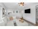 Comfortable living room with a white sectional, decorative pillows, and a modern ceiling fan at 3547 55Th N St, St Petersburg, FL 33710