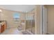 Well-lit bathroom with a bathtub, glass-enclosed shower, and tiled floors at 3862 Tristram Loop, Land O Lakes, FL 34638