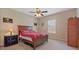 Cozy bedroom with a wood bed frame, ceiling fan, and window at 3862 Tristram Loop, Land O Lakes, FL 34638