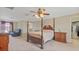 Bedroom boasting a ceiling fan, walk-in closet and a four-post bed at 3862 Tristram Loop, Land O Lakes, FL 34638
