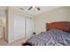Bedroom with a ceiling fan and double closet doors at 3862 Tristram Loop, Land O Lakes, FL 34638