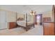 Bedroom with a four poster bed, a ceiling fan, and two dressers at 3862 Tristram Loop, Land O Lakes, FL 34638