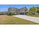 Lovely two-story home featuring a three-car garage, mature palm trees, and a circular driveway at 3862 Tristram Loop, Land O Lakes, FL 34638