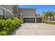 This lovely home has a three car garage and circular drive surrounded by manicured landscaping at 3862 Tristram Loop, Land O Lakes, FL 34638