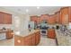 A spacious kitchen featuring stainless steel appliances, granite countertops, and a center island at 3862 Tristram Loop, Land O Lakes, FL 34638