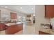 Spacious kitchen features granite countertops, wood cabinets and an island, flowing into the dining area at 3862 Tristram Loop, Land O Lakes, FL 34638