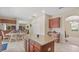 Kitchen with wood cabinets, island with granite counters, and adjacent dining area with bar at 3862 Tristram Loop, Land O Lakes, FL 34638
