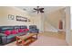 Comfortable living room featuring a leather sofa set, ceiling fan, and stairway at 3862 Tristram Loop, Land O Lakes, FL 34638