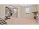 Bright living room with neutral carpet, two windows, archway, and modern ceiling fan with light at 3862 Tristram Loop, Land O Lakes, FL 34638
