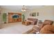 Relax in the living room with a ceiling fan and a beautiful media center at 3862 Tristram Loop, Land O Lakes, FL 34638