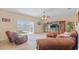 Relax in the living room with sliding glass doors to the patio and a decorative media center at 3862 Tristram Loop, Land O Lakes, FL 34638