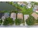 Aerial view of a house with a screened-in pool, neighboring homes, a pond, and mature trees at 4228 Savage Station Cir, New Port Richey, FL 34653