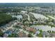 The scenic aerial shows a desirable neighborhood, with homes surrounding tranquil lakes and lush green spaces at 4228 Savage Station Cir, New Port Richey, FL 34653