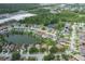 A beautiful aerial view of a home in a neighborhood situated on a lake with lush green landscaping at 4228 Savage Station Cir, New Port Richey, FL 34653