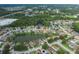 A scenic aerial shot displays a well-maintained suburban community surrounding a pond and lush green landscape at 4228 Savage Station Cir, New Port Richey, FL 34653