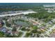 Aerial view of a home located in a waterside community with tree coverage and sidewalks at 4228 Savage Station Cir, New Port Richey, FL 34653