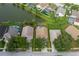 Aerial view of a house with a screened-in pool, neighboring homes, a pond, and mature trees at 4228 Savage Station Cir, New Port Richey, FL 34653
