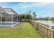 This property has a pool, a wooden fence, and a scenic view of a lake that enhances its appeal at 4228 Savage Station Cir, New Port Richey, FL 34653