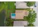 Aerial view of a private backyard with a screened pool and well-kept lawn at 4228 Savage Station Cir, New Port Richey, FL 34653