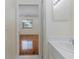 Bathroom vanity leading to a bedroom with hardwood floors and a ceiling fan at 4228 Savage Station Cir, New Port Richey, FL 34653