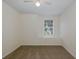 Bedroom with neutral walls, carpet flooring, a ceiling fan and a window facing the outside at 4228 Savage Station Cir, New Port Richey, FL 34653