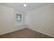 A bedroom with neutral walls and carpet flooring has a window facing the outside at 4228 Savage Station Cir, New Port Richey, FL 34653