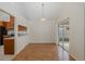 Dining room with hardwood floors, slider to lanai, and pass through to kitchen at 4228 Savage Station Cir, New Port Richey, FL 34653