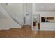 Bright entryway featuring hardwood floors, high ceilings, a staircase, and partial view of the kitchen at 4228 Savage Station Cir, New Port Richey, FL 34653