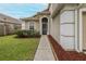 Close-up of the front of the home with landscaped garden and walkway leading to the entrance at 4228 Savage Station Cir, New Port Richey, FL 34653