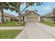 A cozy two-story home featuring a two-car garage and a well-manicured lawn at 4228 Savage Station Cir, New Port Richey, FL 34653