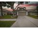Inviting two-story home with a neutral exterior, two-car garage, and well-maintained front lawn at 4228 Savage Station Cir, New Port Richey, FL 34653