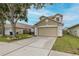 A cozy two-story home featuring a two-car garage and a well-manicured lawn at 4228 Savage Station Cir, New Port Richey, FL 34653