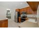 Well-lit kitchen with stainless steel appliances and wood cabinets at 4228 Savage Station Cir, New Port Richey, FL 34653