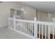 Lofted landing with white railings overlooking the entry and stairs at 4228 Savage Station Cir, New Port Richey, FL 34653