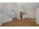 Bright living room with an open floor plan, hardwood floors, and staircase at 4228 Savage Station Cir, New Port Richey, FL 34653