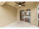 Covered patio with ceiling fan and sliding glass door entrance to home at 4228 Savage Station Cir, New Port Richey, FL 34653