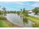 This home has a view of a pond that is framed by lush trees, enhancing its natural beauty at 4228 Savage Station Cir, New Port Richey, FL 34653