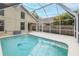 Inviting screened pool and patio area with surrounding lush greenery at 4228 Savage Station Cir, New Port Richey, FL 34653