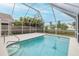 Inviting screened pool and patio area with surrounding lush greenery at 4228 Savage Station Cir, New Port Richey, FL 34653