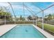 A screened in pool with clear blue water offers a private backyard space for relaxation and entertainment at 4228 Savage Station Cir, New Port Richey, FL 34653