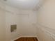Walk-in closet with wood floor, wire rack shelving, and access to electrical at 4228 Savage Station Cir, New Port Richey, FL 34653
