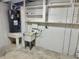Unfinished basement area with concrete floor, water heater and shelving at 440 89Th Ave, St Pete Beach, FL 33706