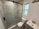 Modern bathroom featuring a glass-enclosed shower with tile surround and updated fixtures at 440 89Th Ave, St Pete Beach, FL 33706
