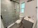 Bathroom featuring a glass enclosed shower with tile walls and floor, and a gray vanity at 440 89Th Ave, St Pete Beach, FL 33706