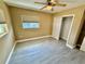 Cozy bedroom featuring a ceiling fan, window, closet, and wood look flooring at 440 89Th Ave, St Pete Beach, FL 33706