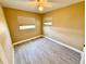 This bedroom features modern tile floors, neutral paint, ceiling fan, and natural light through window at 440 89Th Ave, St Pete Beach, FL 33706